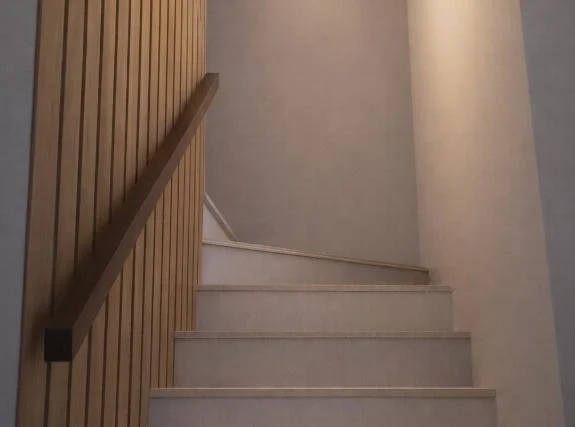Interior staircase with wood side paneling and light-colored steps.