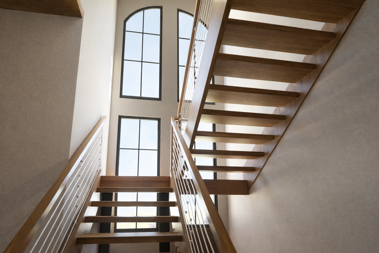 Interior staircase with wood treads and large arched windows.