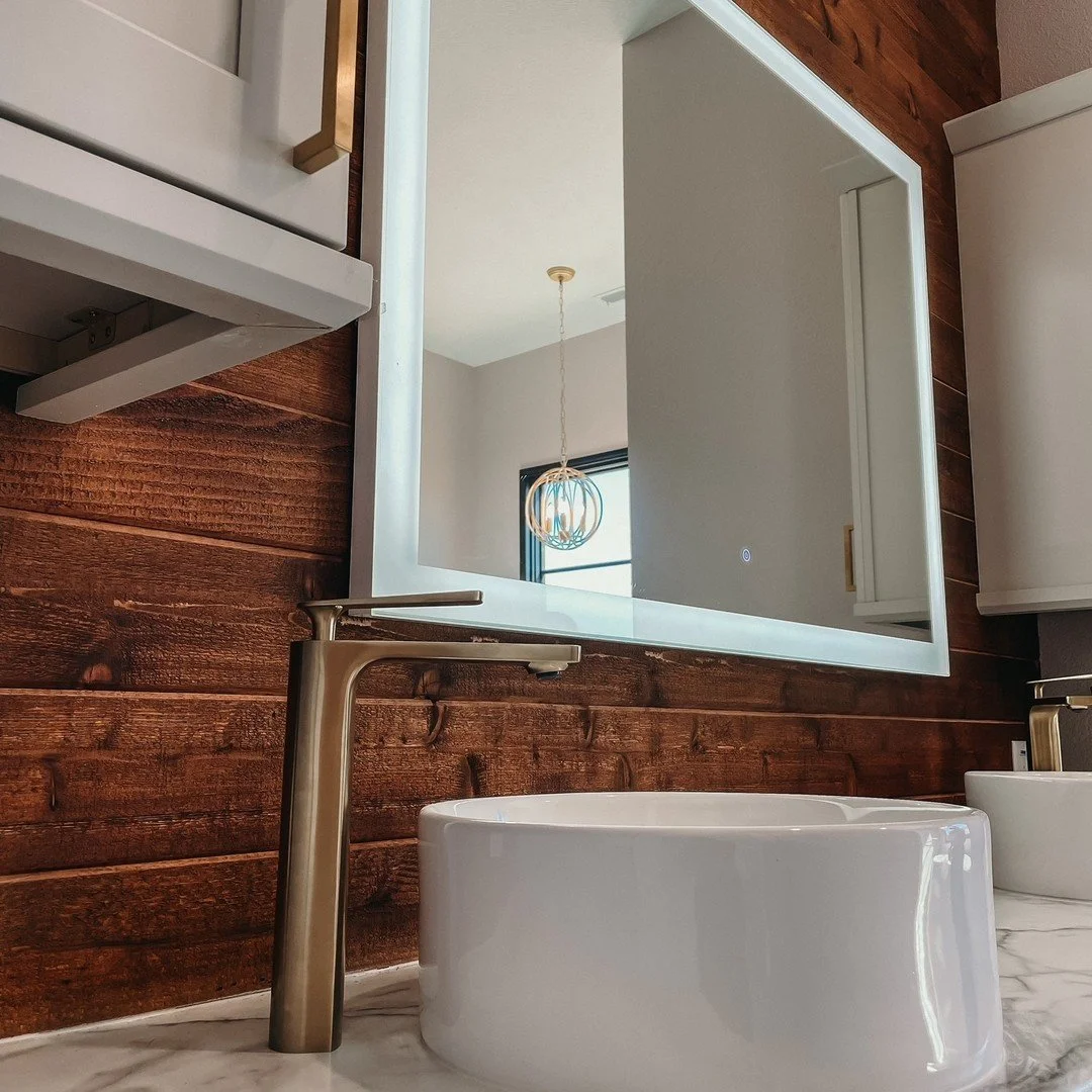 Bathroom vanity with sink and wall-mounted mirror.