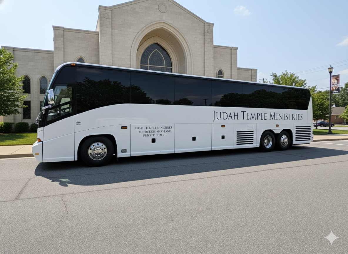 A white bus with black windows parked on a street in front of a church with arched windows and stone exterior. The bus has 'Judah Temple Ministries' written on the side.