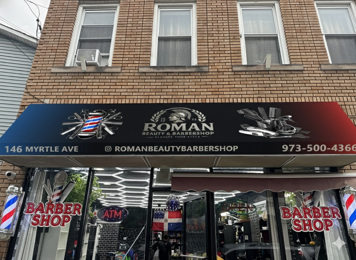 Barber shop storefront with barber signs, a barber pole, and barber tools on the awning. Inside, visible through the glass, are people and salon equipment, including a Dominican flag.