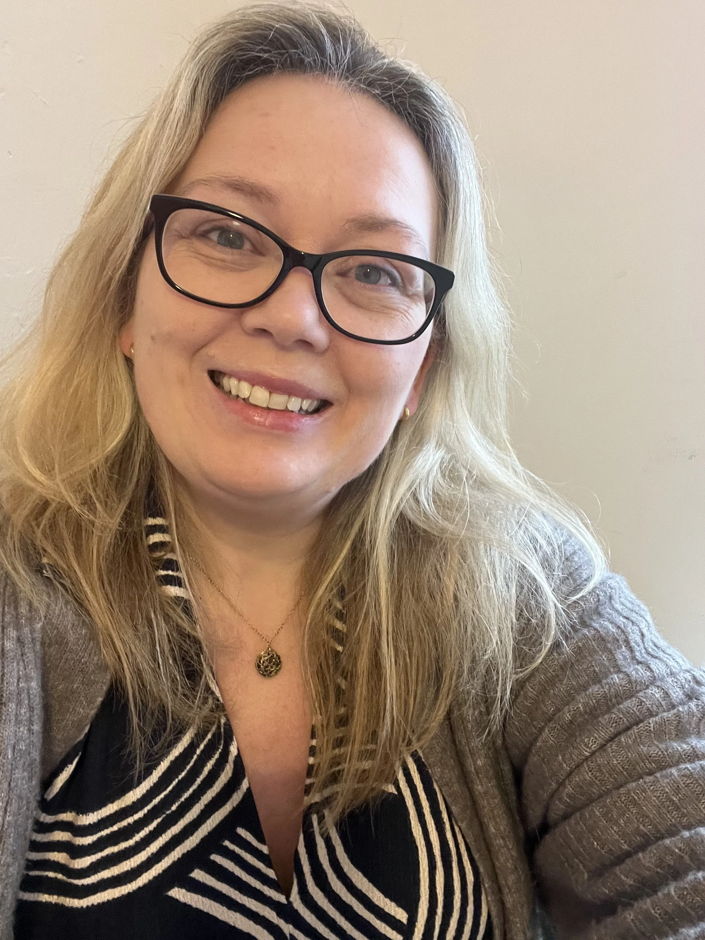 Warm, approachable therapist smiling