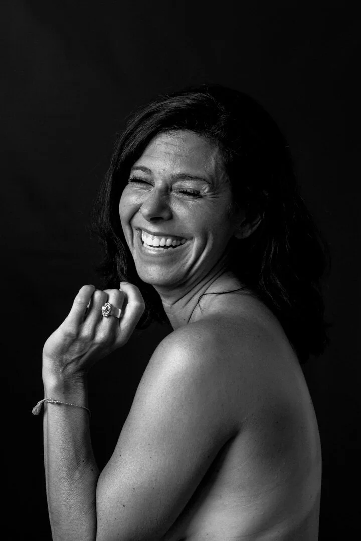 A woman, unclothed, smiling