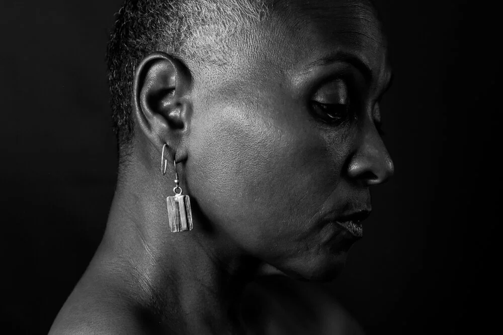 Close image of a black woman wearing earrings