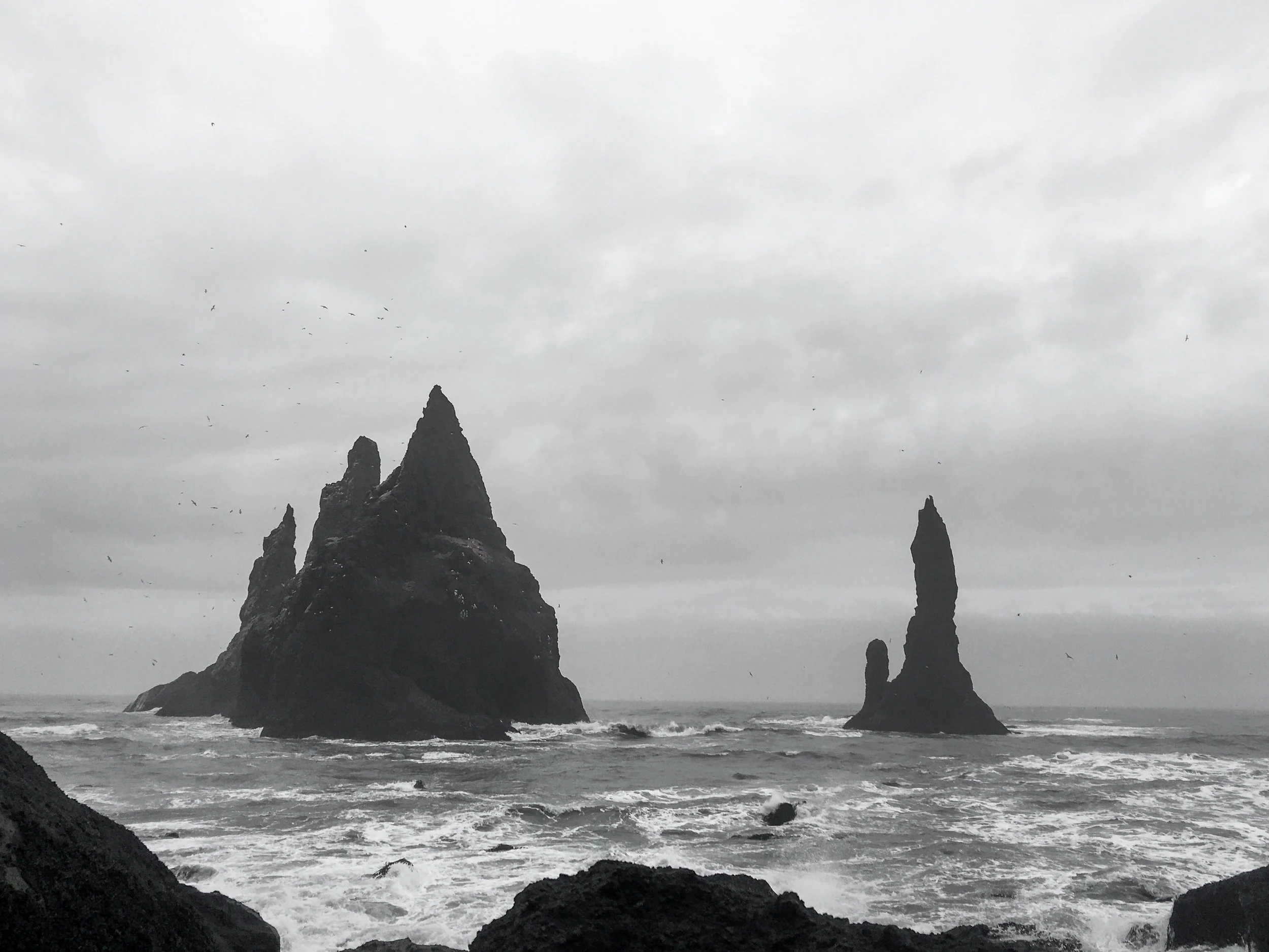 The volcanic rock juts out of the ocean in Vik, Iceland, in these documentary images