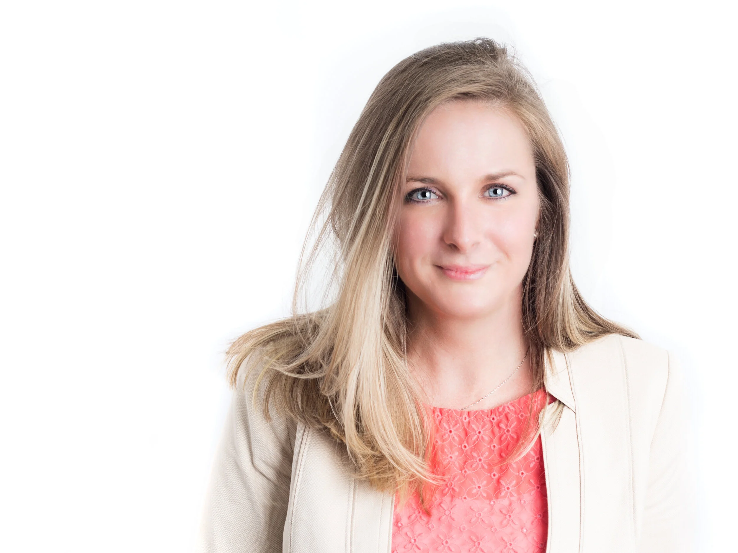 Woman with blonde hair wearing a cream blazer posing for professional corporate headshot in Cleveland