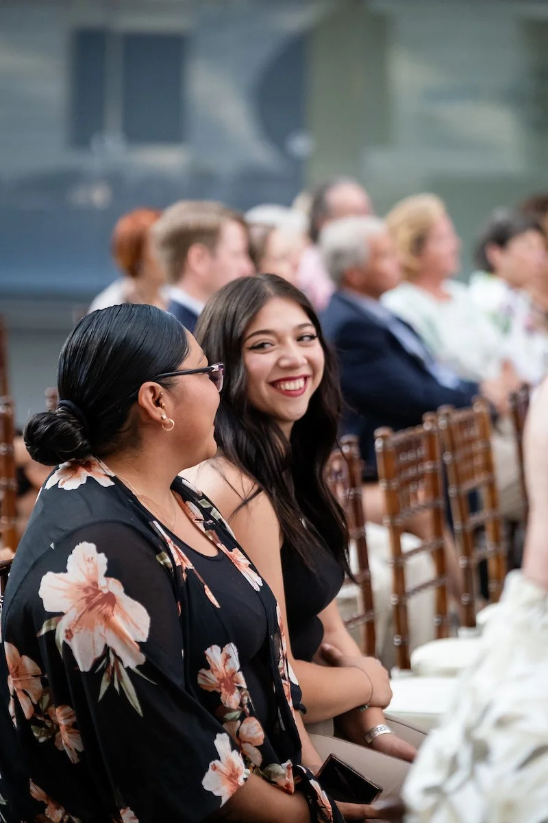 A woman from Mexico smiles at her friend at an event in Cleveland