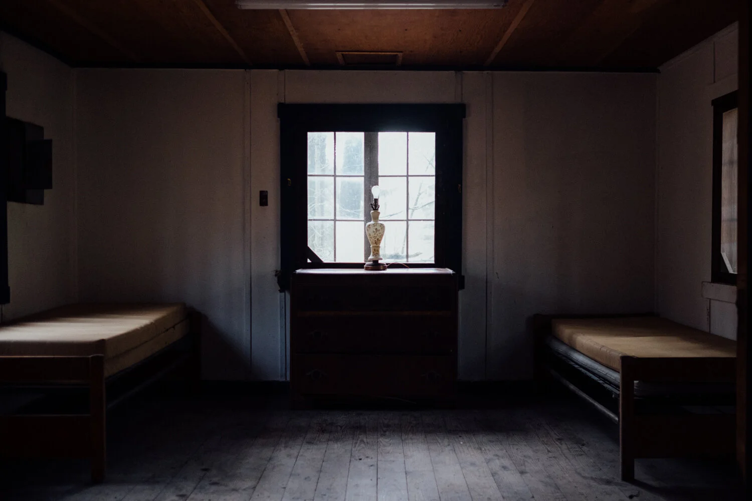 Documentary photo of an abandoned girl scout camp bunk