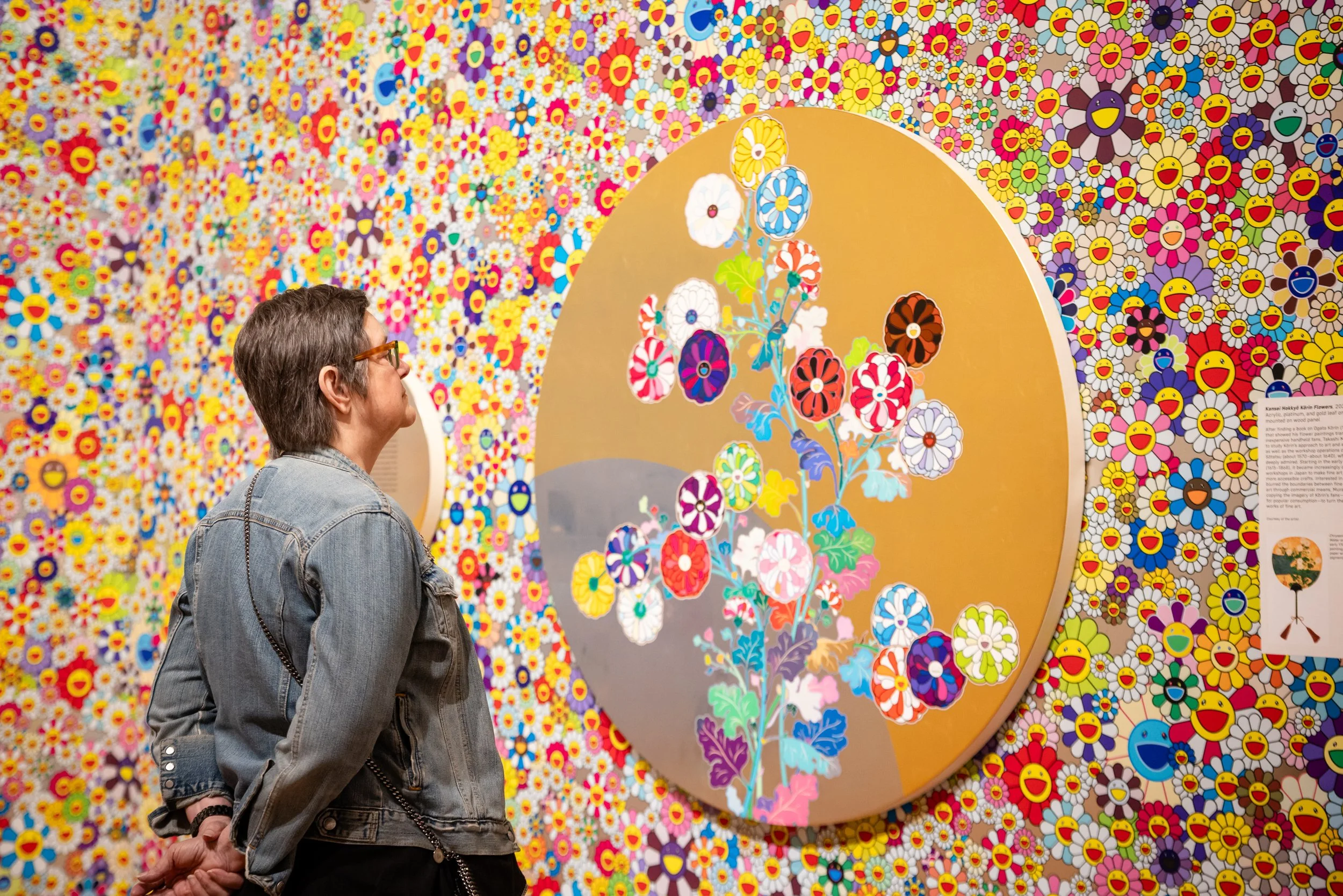 Woman admiring art work done by Takashi Murakami at an elite exhibition opening in Cleveland, Ohio