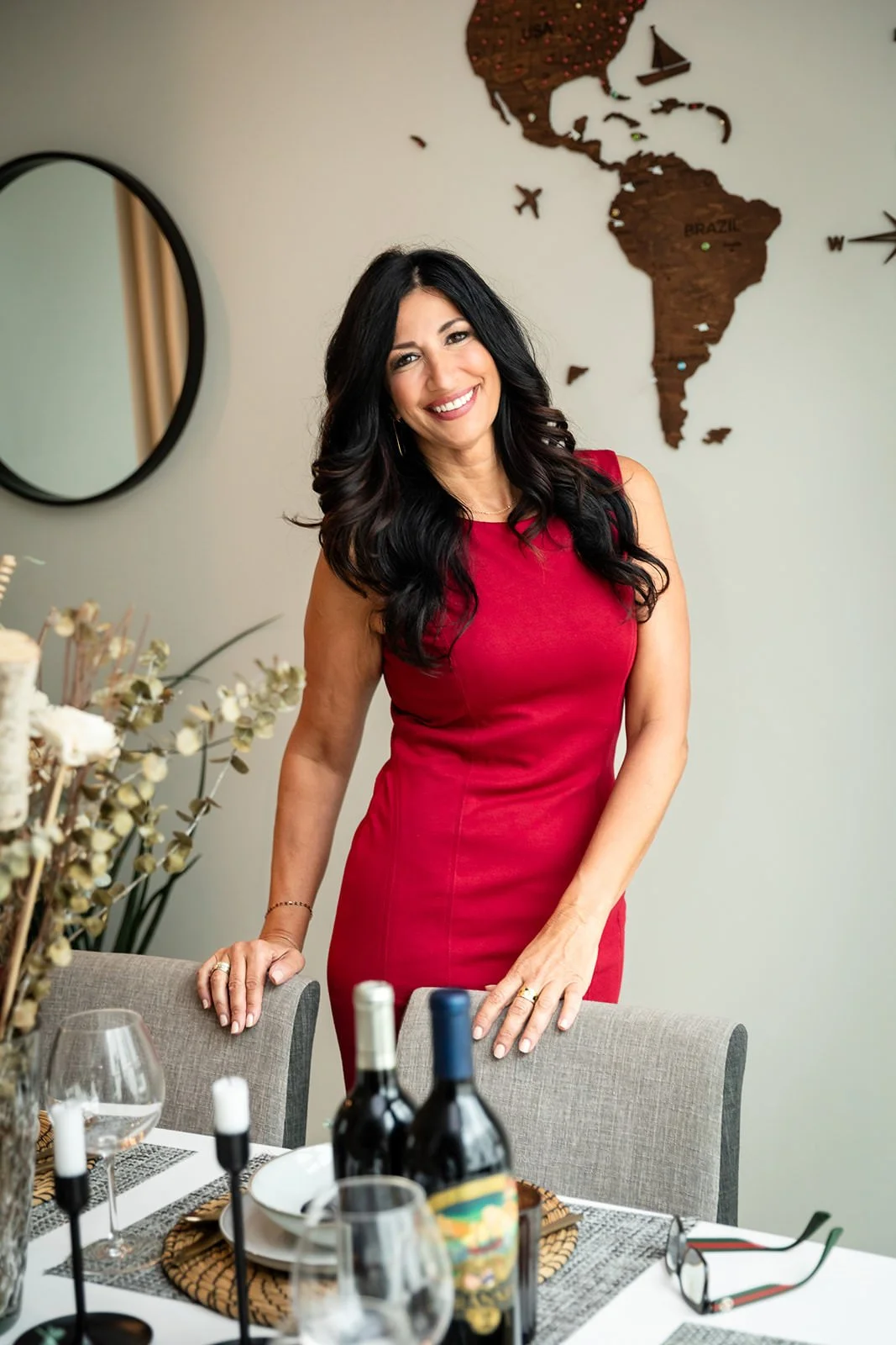 Frances DiBello, a business consultant specializing in IT and business strategy, standing confidently by a beautifully set dining table, symbolizing her approachable yet professional demeanor.