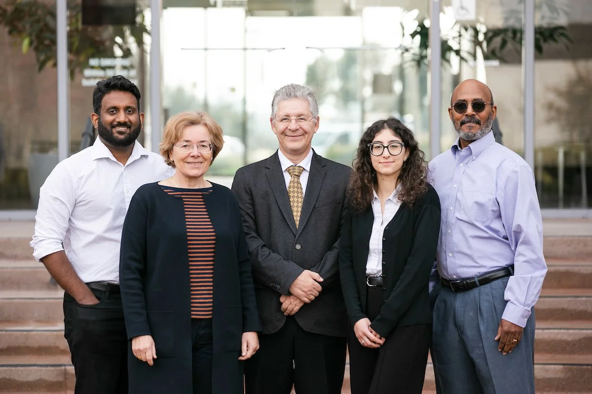 Five individuals of the SageMedic team photographed standing together in front of their laboratory in California.