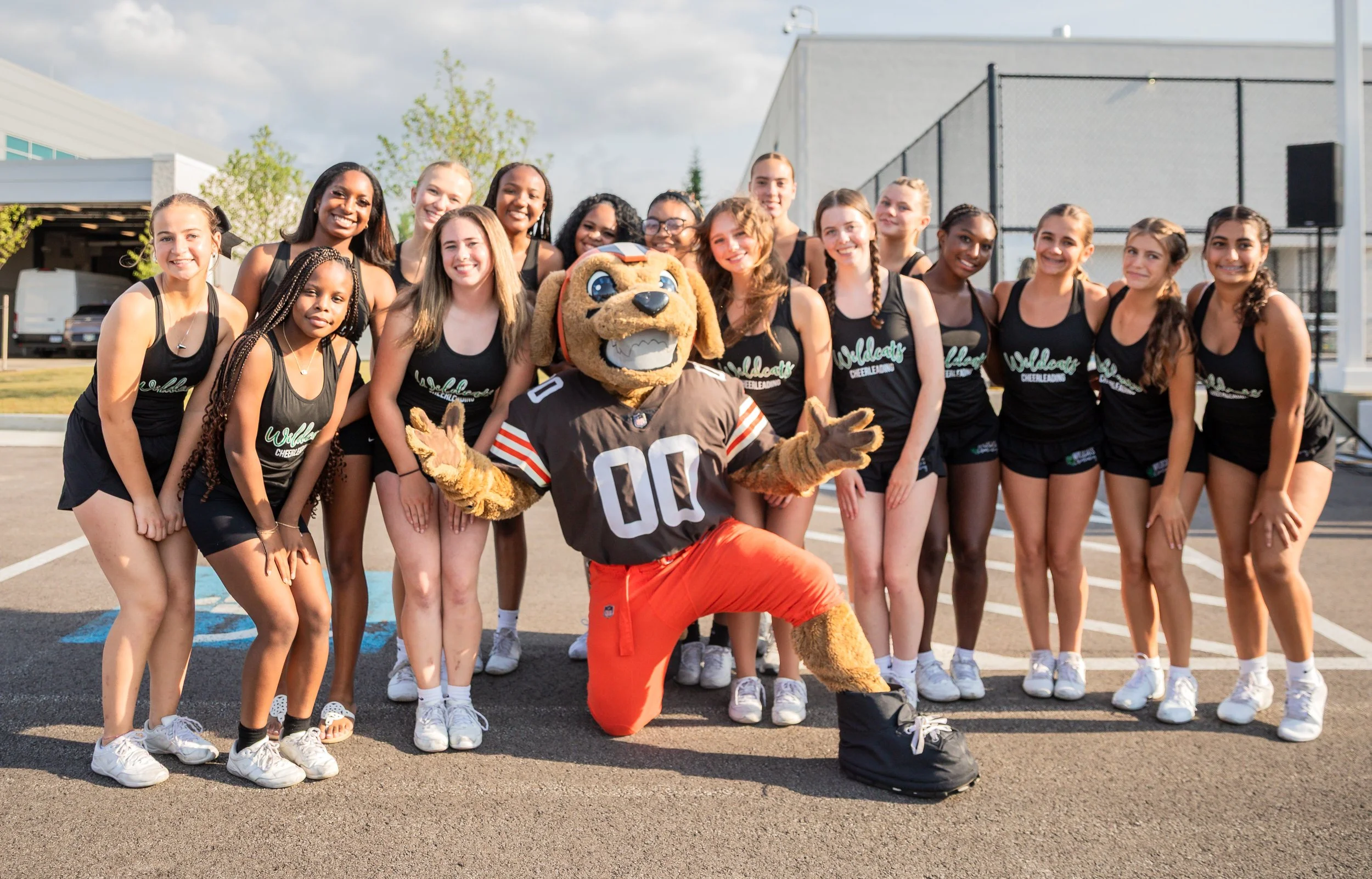 A group of young cheerleaders poses with Swagger (Cleveland Browns) during an event