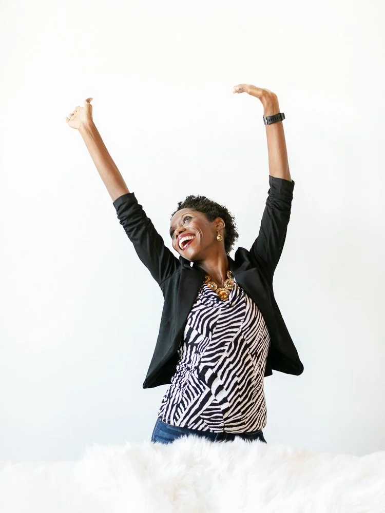 Employee candid moment at a corporate headshot day, raising hands and laughing