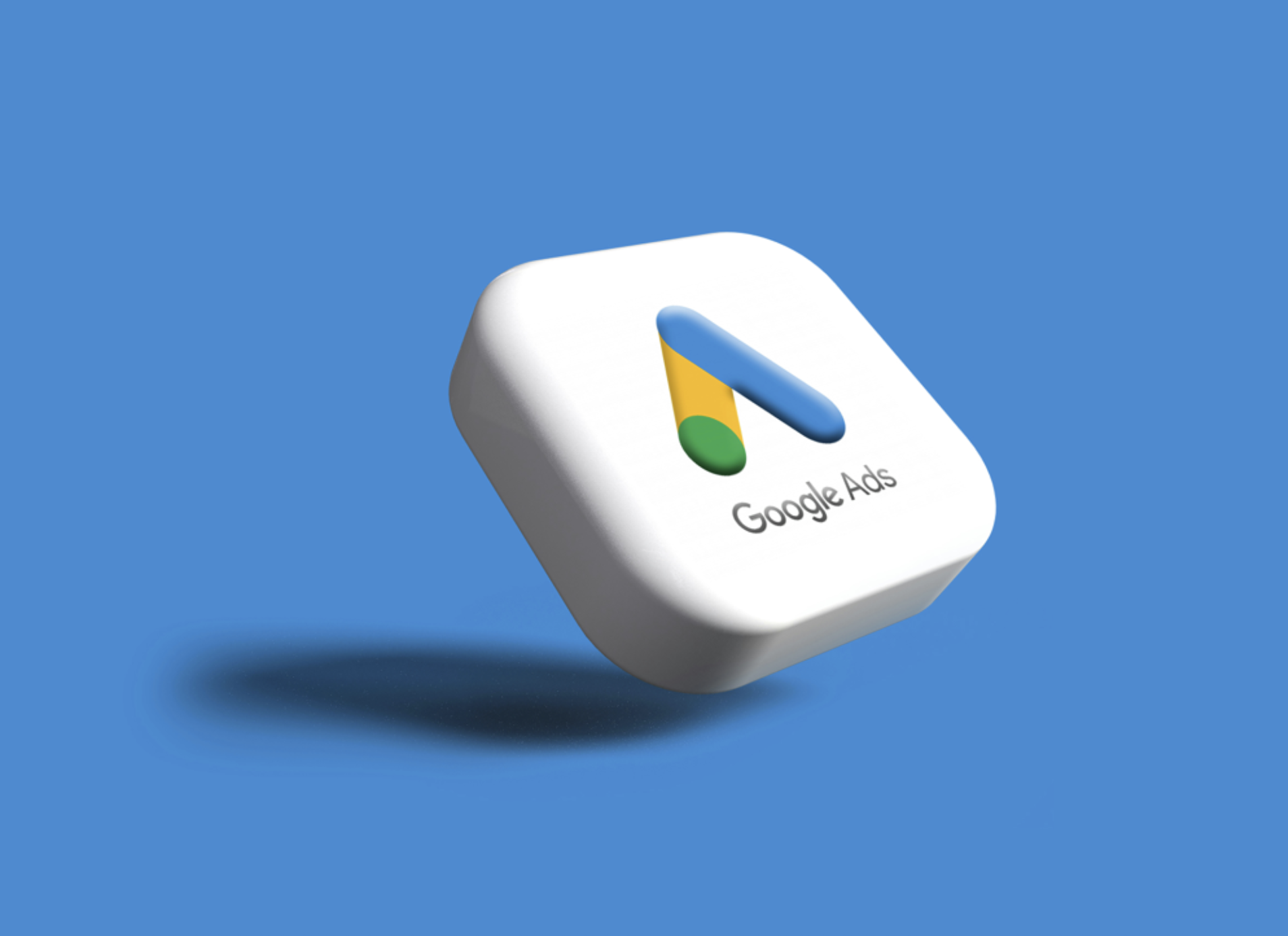 3D illustration of a rounded white cube with the Google Ads logo on top, floating against a blue background.