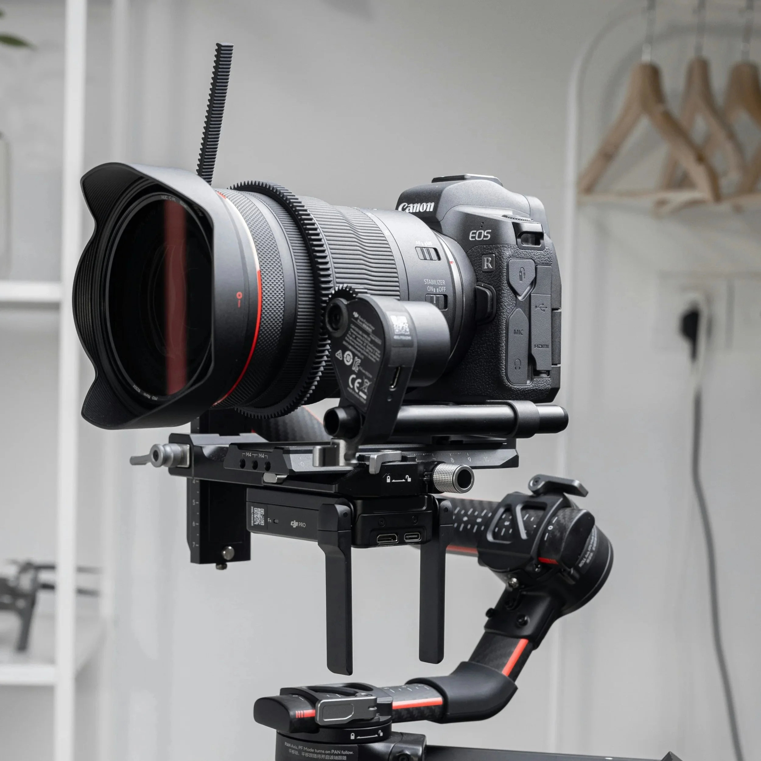 A professional camera mounted on a stabilizer rig indoors.