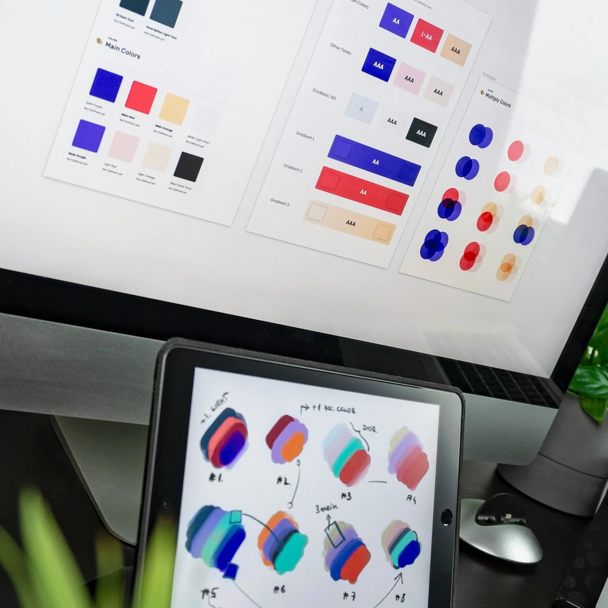 Images of color palette design charts with various color swatches and gradient samples on a computer screen and tablet.
