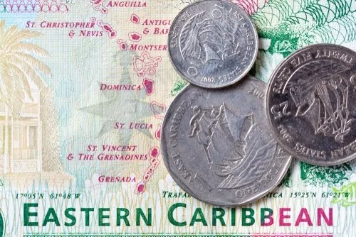 Close-up of a map of the Eastern Caribbean with three coins placed on it.