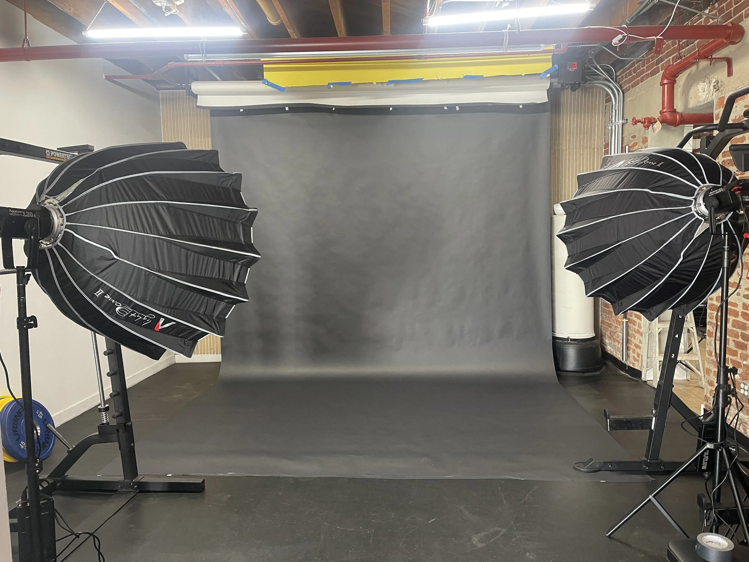 Professional seamless backdrop photoshoot setup with studio lighting in a private Los Angeles fitness and content creation studio for editorial photography and video production.