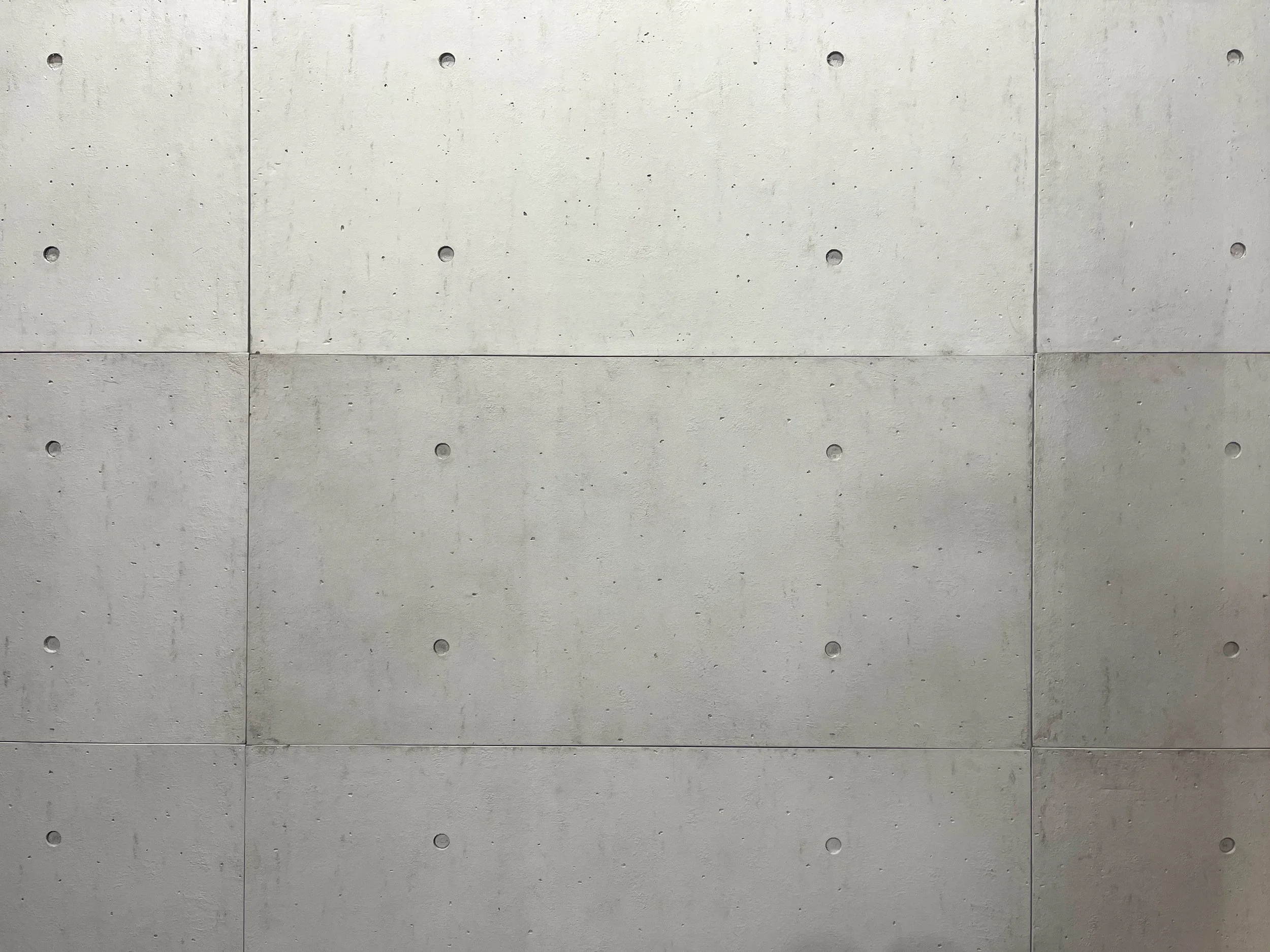 Concrete panel texture wall backdrop in a private Los Angeles fitness and content creation studio for editorial photography and video shoots.