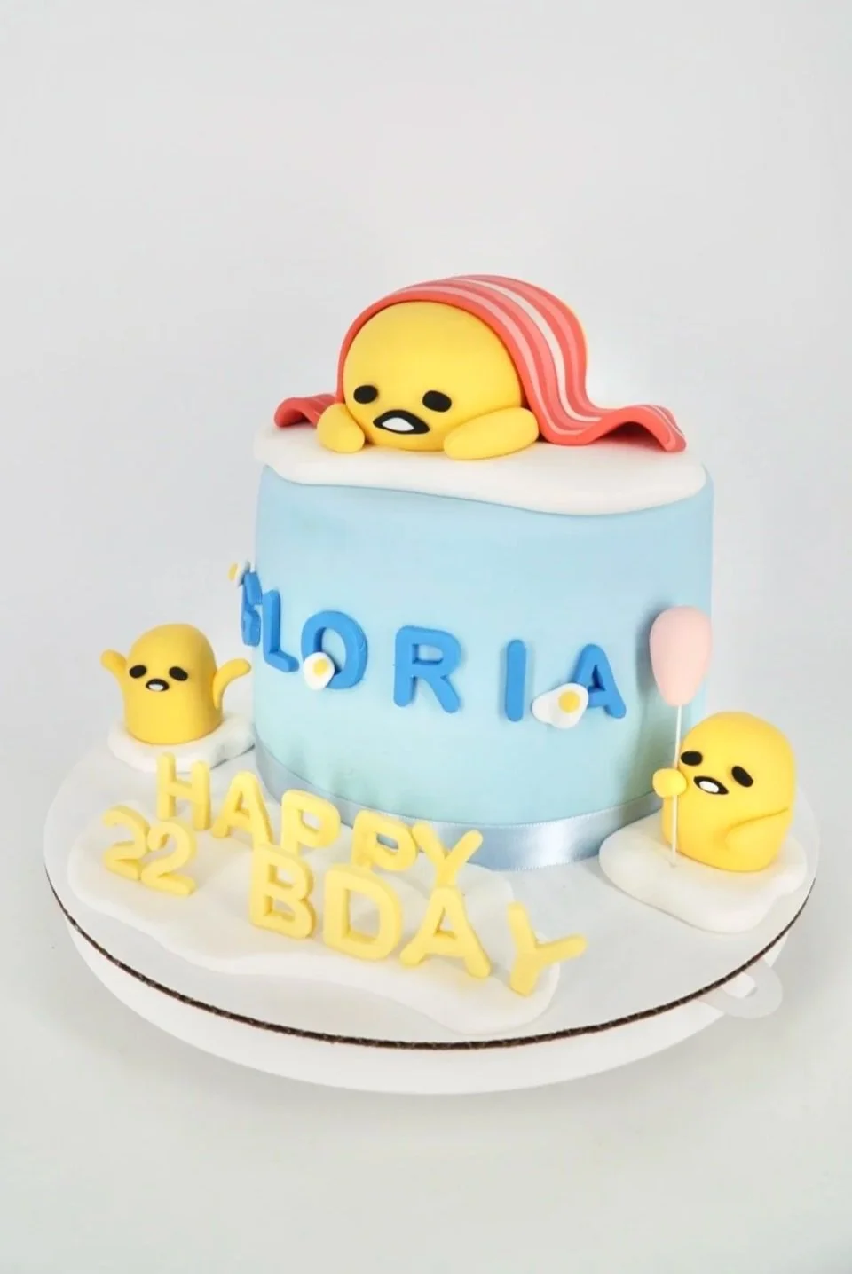 Close-up image of rice crispy treats topped with chocolate coating and crushed candies.