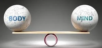 Two spheres labeled 'BODY' and 'MIND' balancing on a seesaw.