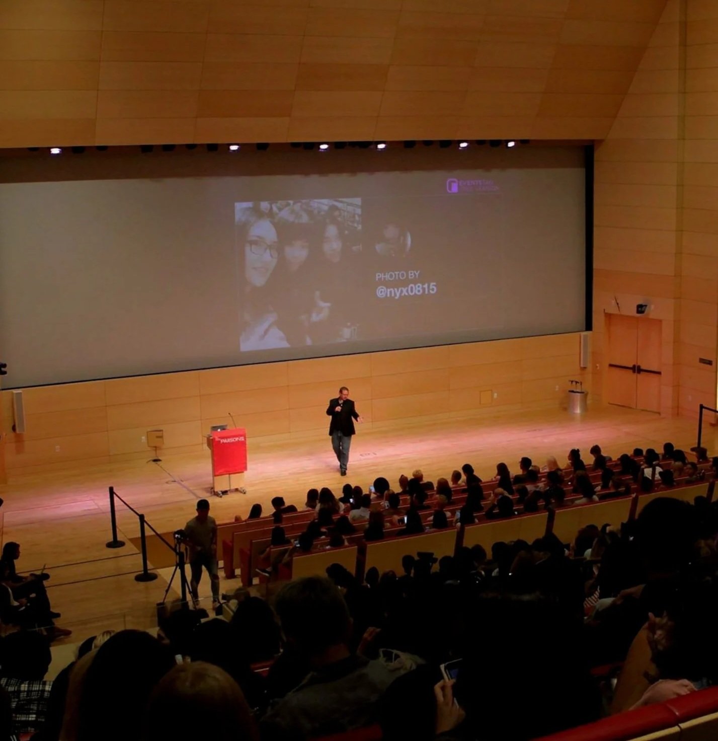 Thomas Werner on stage speaking at an event.