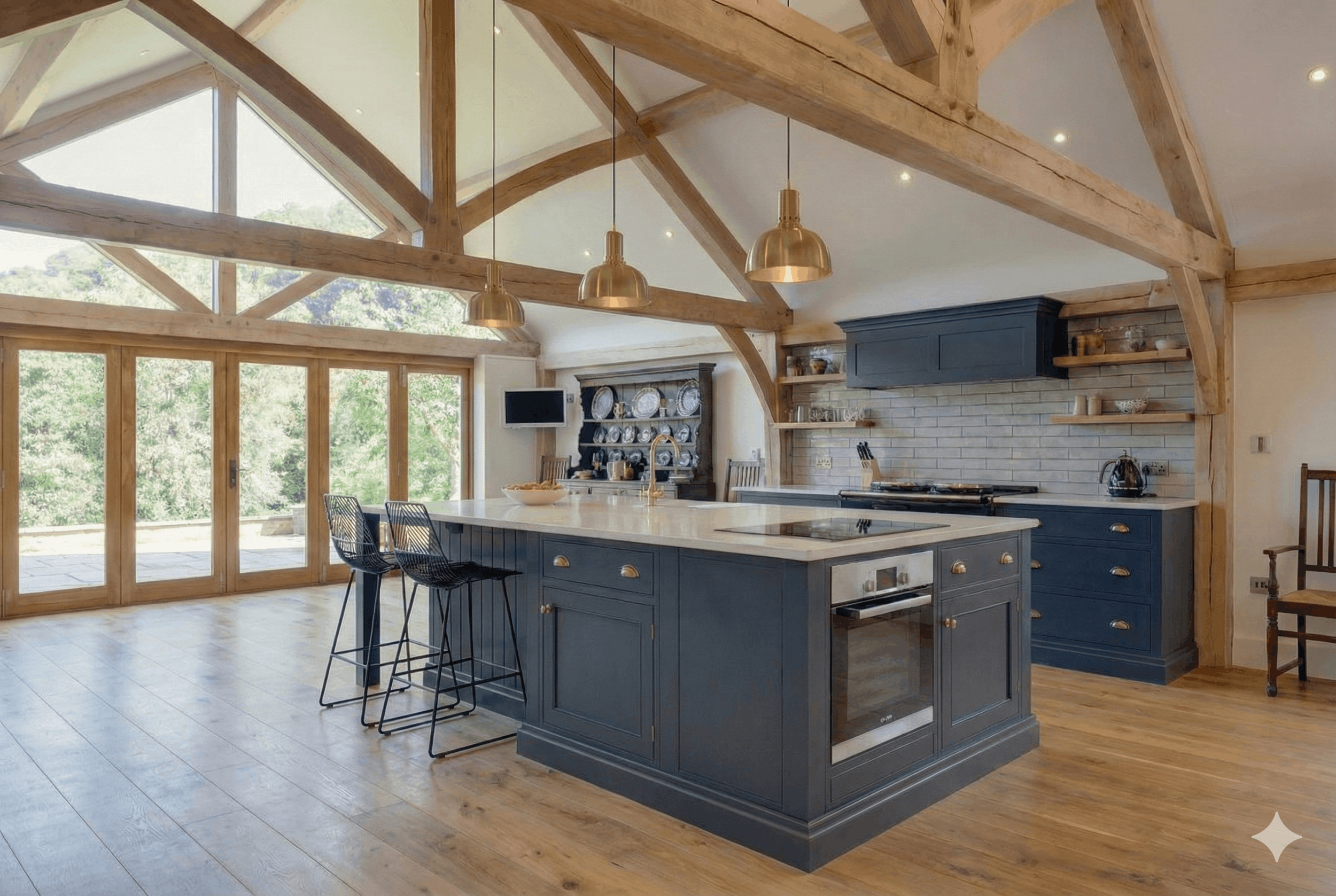 Open-concept kitchen with a large island, dark blue cabinets, wooden beams, and large windows showing a green outdoor view.
