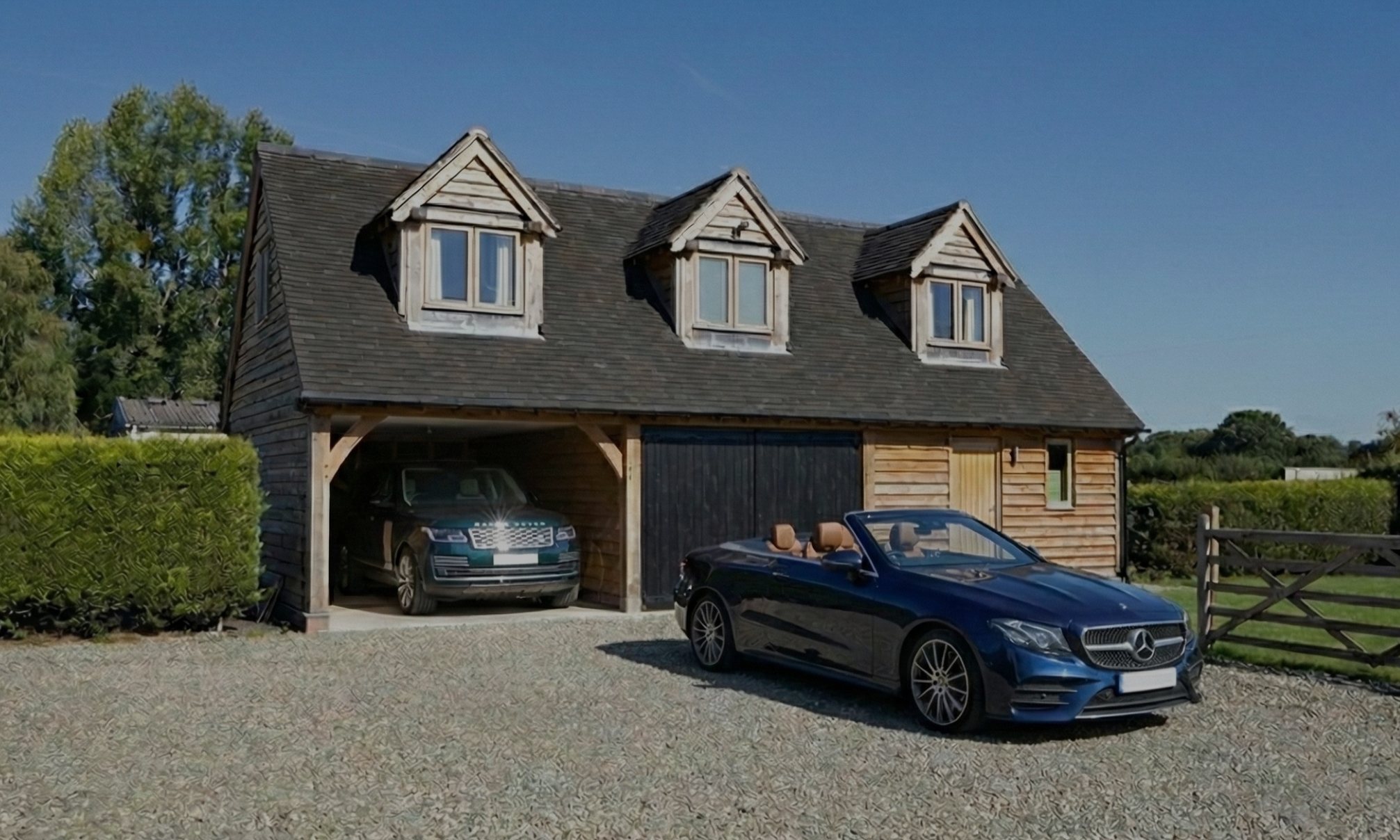 Detail of a bespoke oak-framed building featuring an upper floor room and traditional timber joinery.