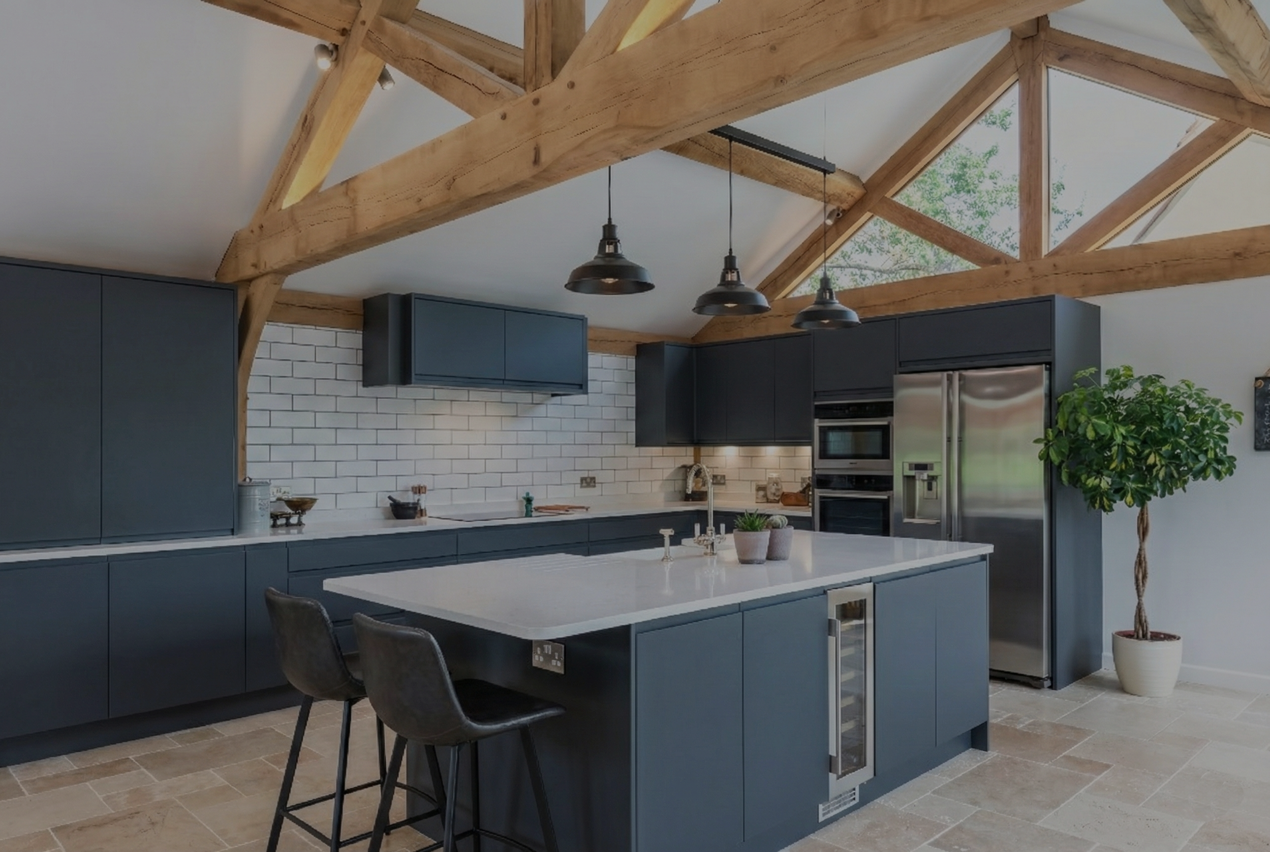 Interior of a modern oak framed annexe showing vaulted ceilings and natural timber beams