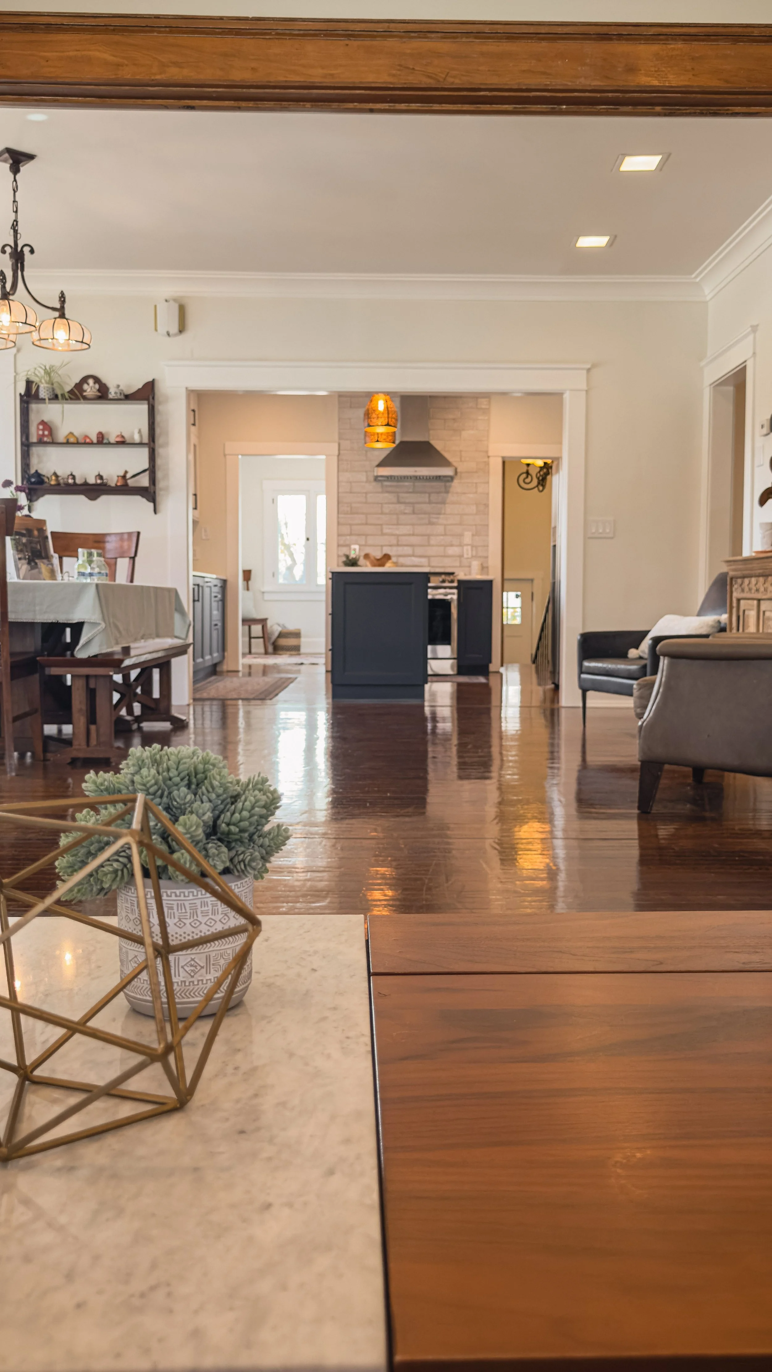 Long interior view through the living and dining areas toward the kitchen at the Emerson residence in Salt Lake City.