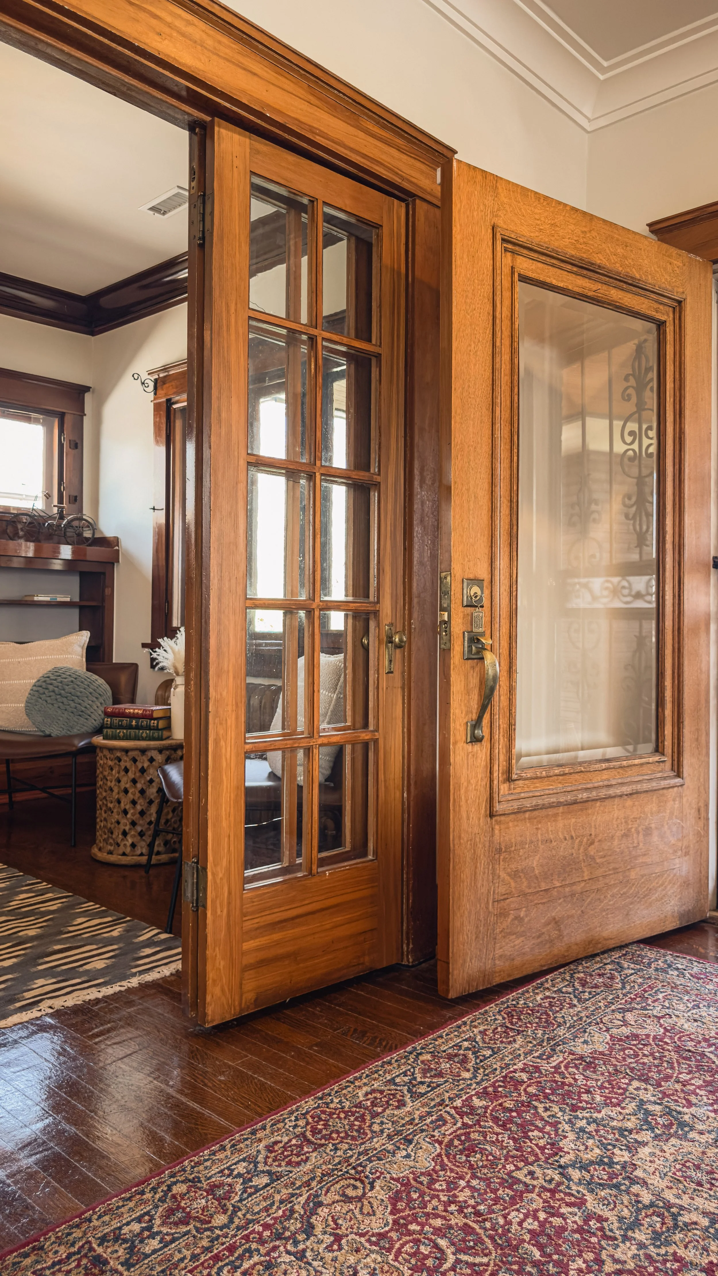 Wood entry door and glass French doors opening into the living area of the Emerson residence in Salt Lake City.
