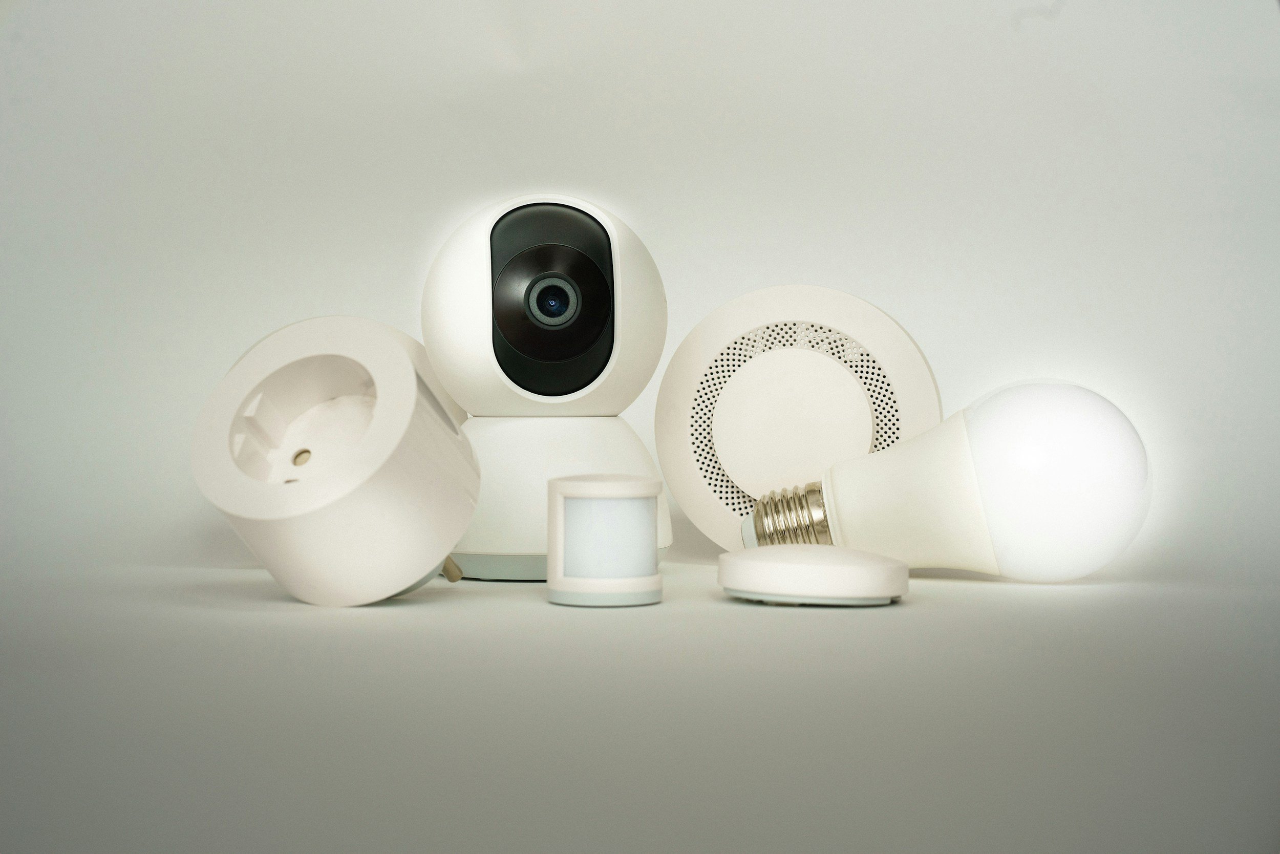 A collection of light bulbs, some turned on and some off, with a security camera mounted on the ceiling.