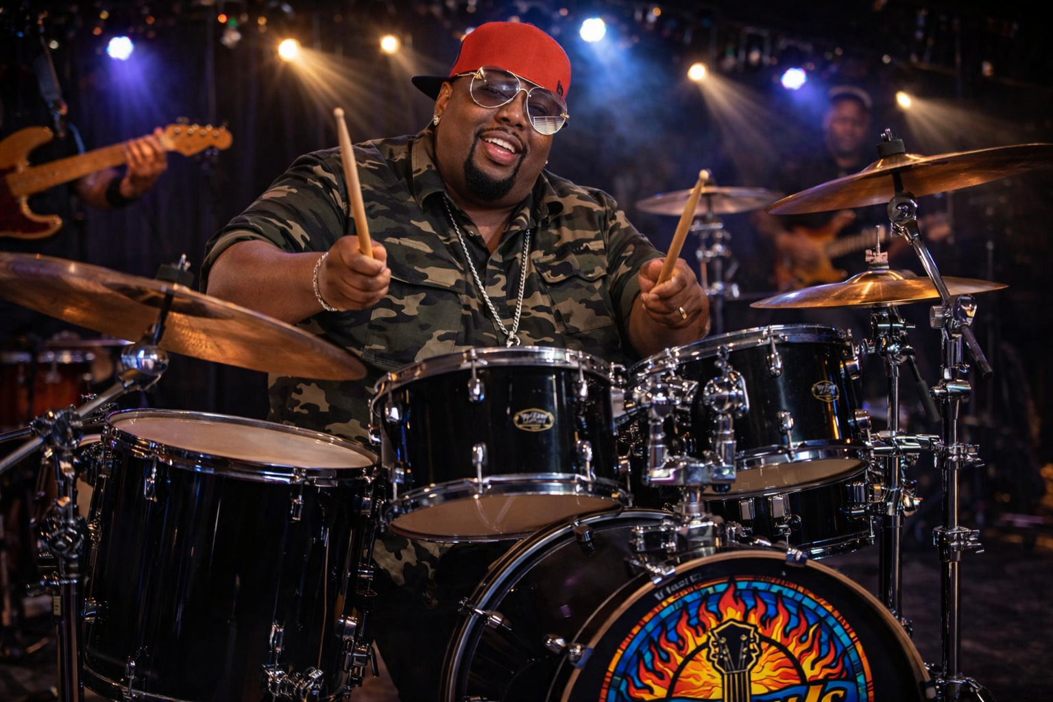 Musician playing the drums on stage with colorful lights in the background