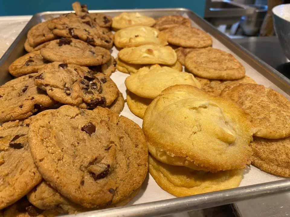 A baking sheet filled with chocolate chip cookies, sugar cookies, and snickerdoodles.