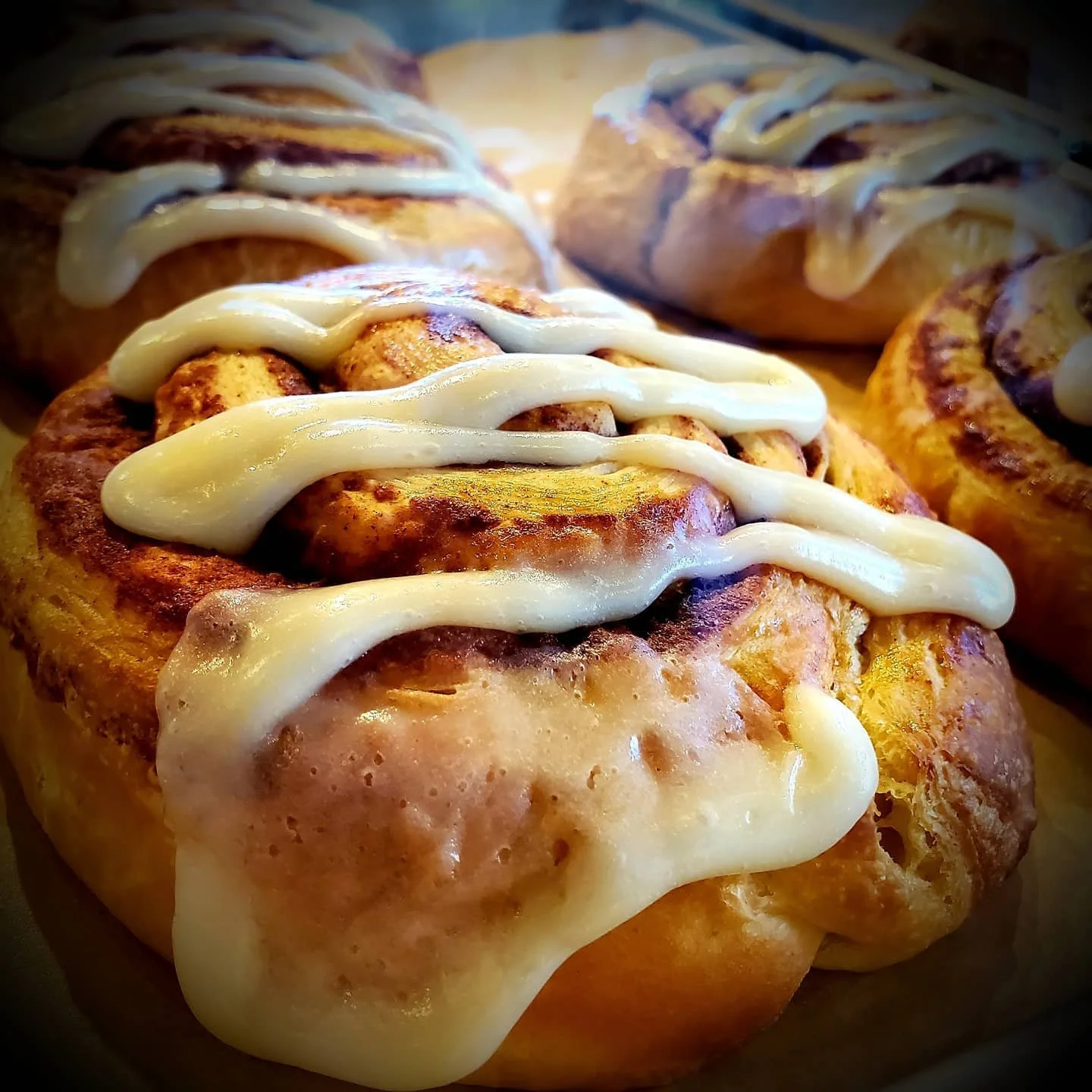 Close-up of cinnamon rolls with icing on top