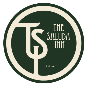 The logo of The Saluda Inn, established in 1880, featuring a circular design with the initials 'TSI' and the inn's name.
