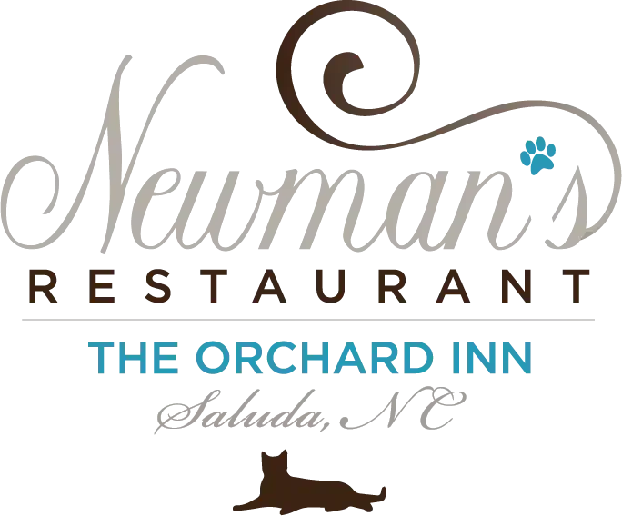 Logo for the restaurant 'Nebraska Restaurant, The Orchard Inn,' with decorative script, a small star, and a horizontal line separating the name from 'The Orchard Inn' text.