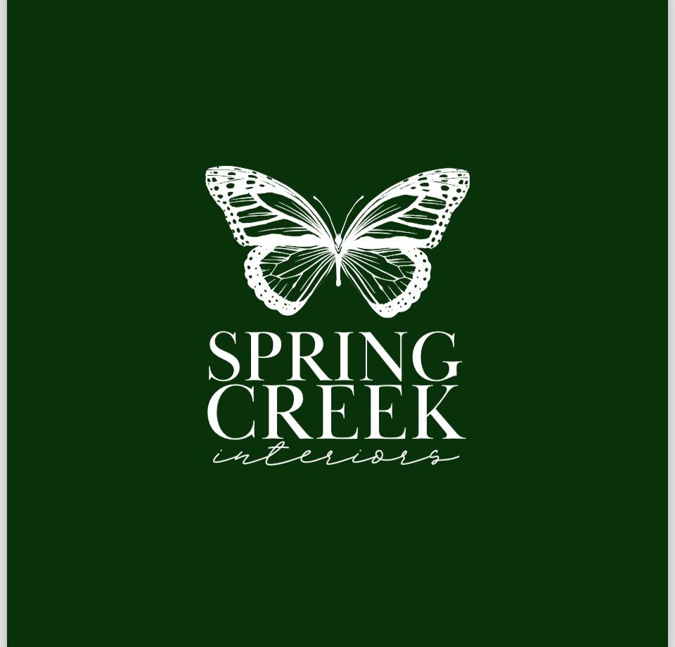 Logo for Spring Creek Interiors featuring a white butterfly on a dark green background with the company's name.