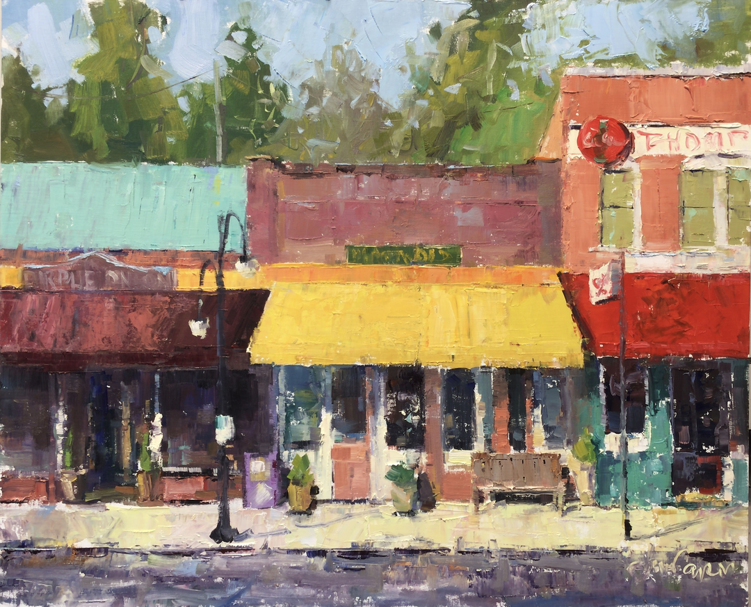 An oil painting of a colorful street scene with storefronts, a lamppost, and a sidewalk in front. The buildings have awnings in various colors such as yellow, red, and purple, with trees and a blue sky in the background.