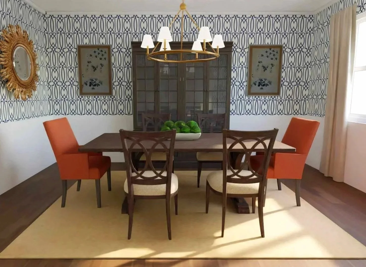 Dining room with patterned wallpaper, six wooden chairs around a rectangular table, two orange upholstered chairs, a wooden chandelier with six white lampshades, a beige rug, a large bowl of green balls, a curved glass-front cabinet, framed floral ar