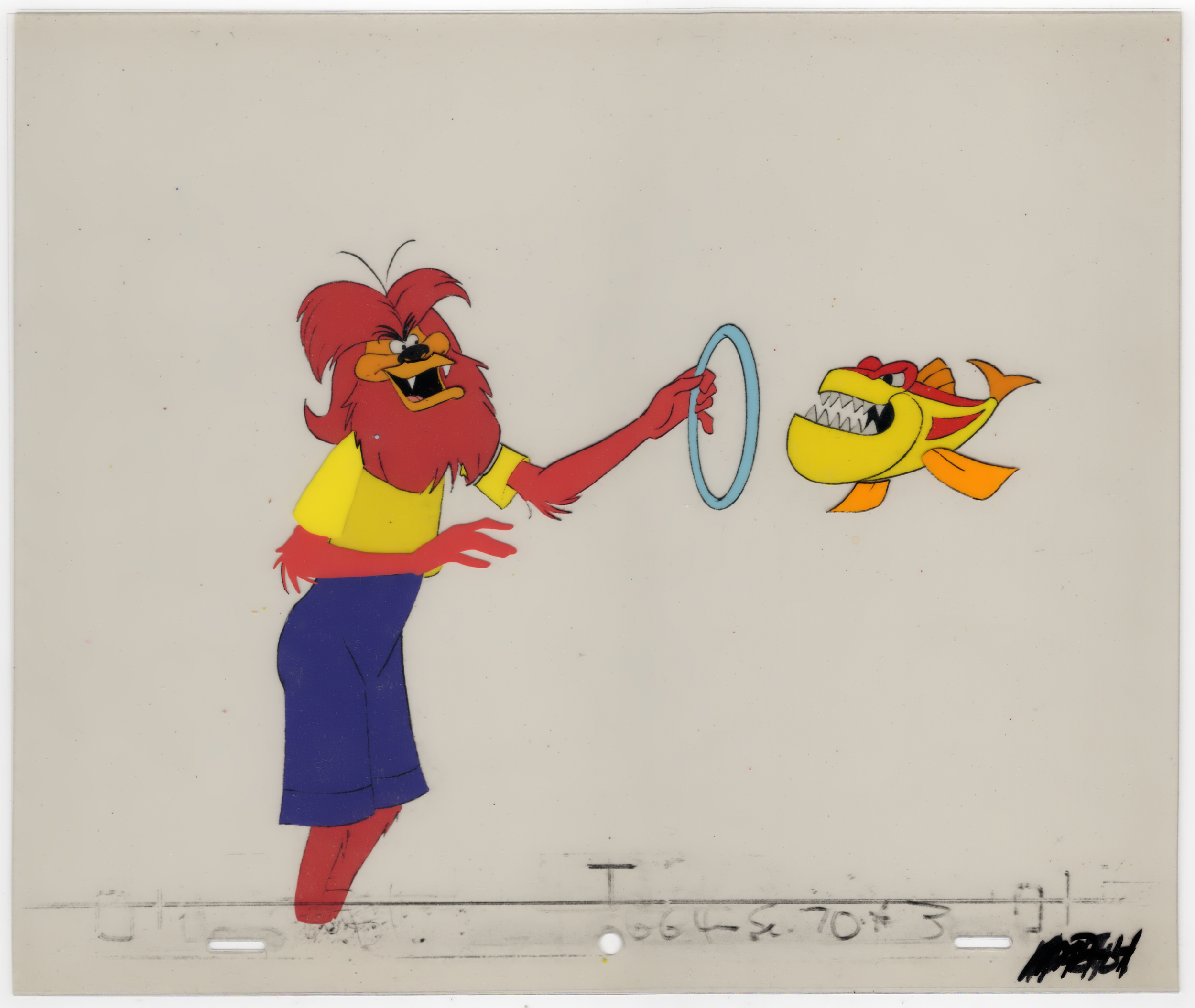 A vintage animation cel featuring a red lion with a yellow shirt holding a blue ring, interacting with a yellow and orange fish with sharp teeth. The backdrop is plain white with faint markings and handwriting at the bottom.