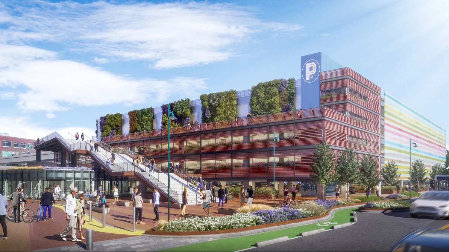 A modern multi-story parking garage with green rooftop gardens and surrounding pedestrian area with people walking, trees, and colorful landscaping.