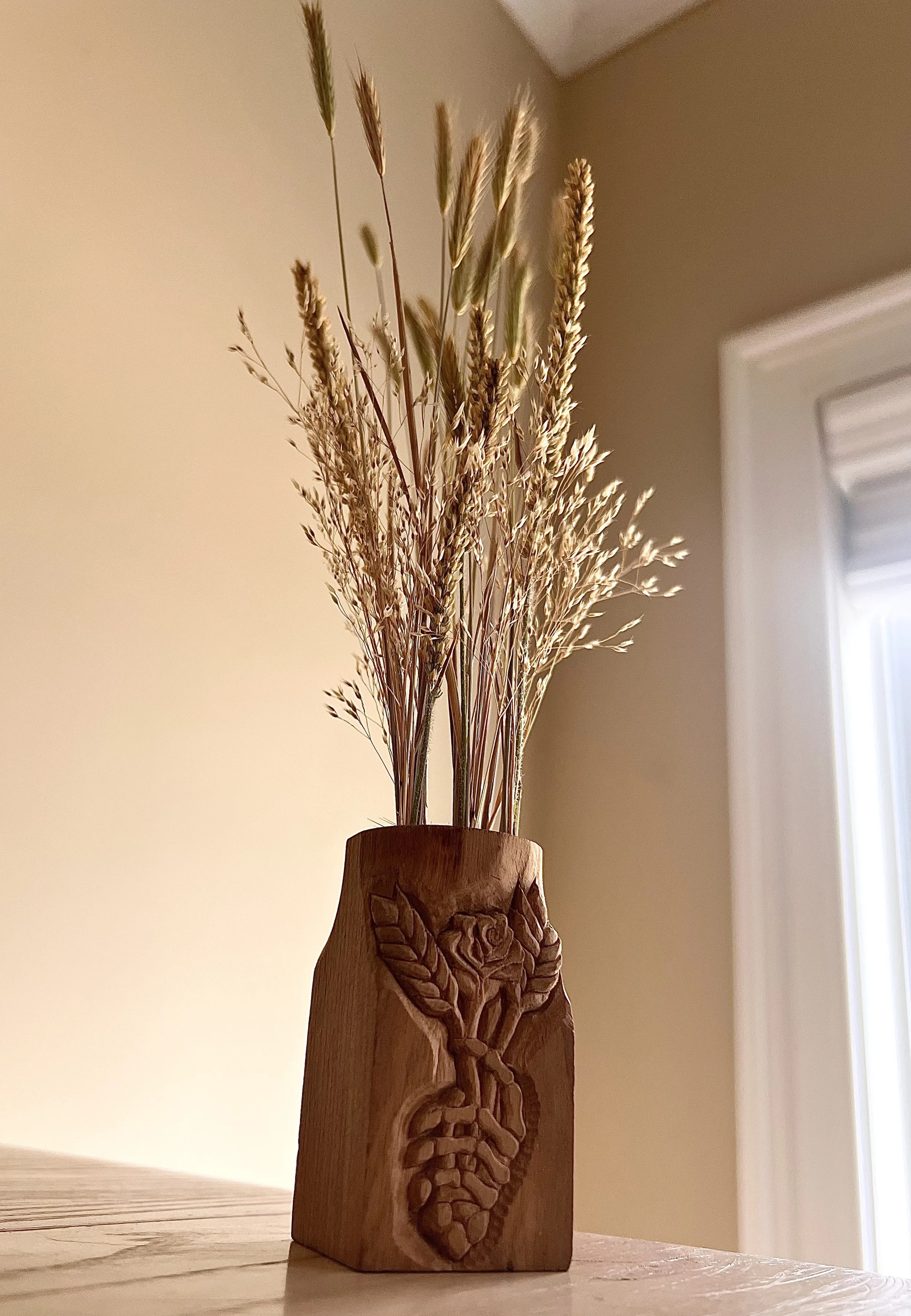 "From Birth Until Life Closes" Hand carved dried flower vase, unfinished, scrap wood. Bread and Roses series, relief carved motif. 