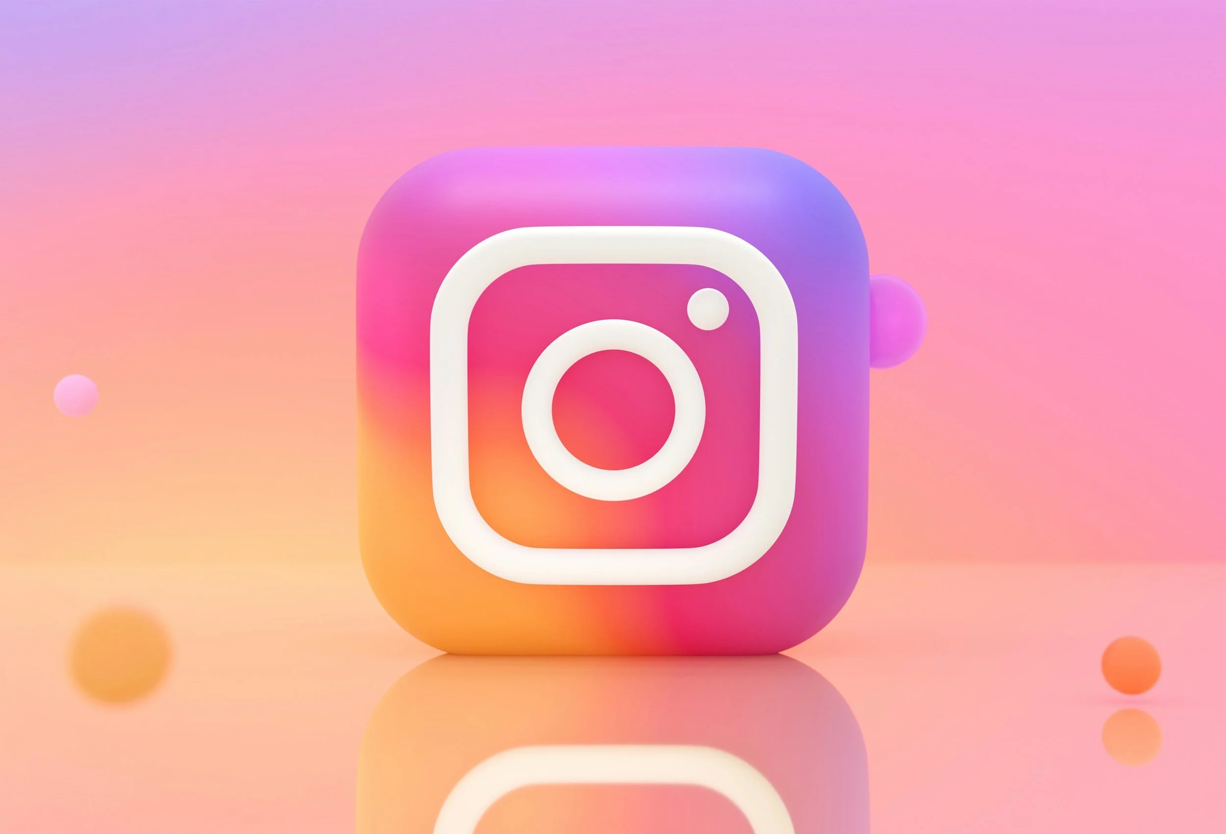 Instagram logo icon with a white outline on a colorful gradient background of pink, purple, and orange with floating spheres.