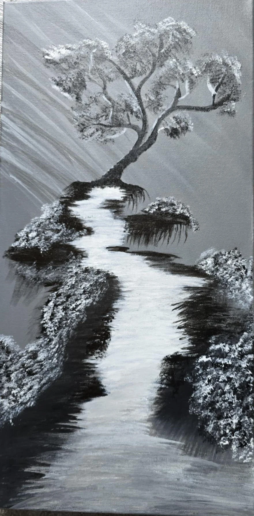 A black and white painting of a tree growing from a rocky hill above a winding river.