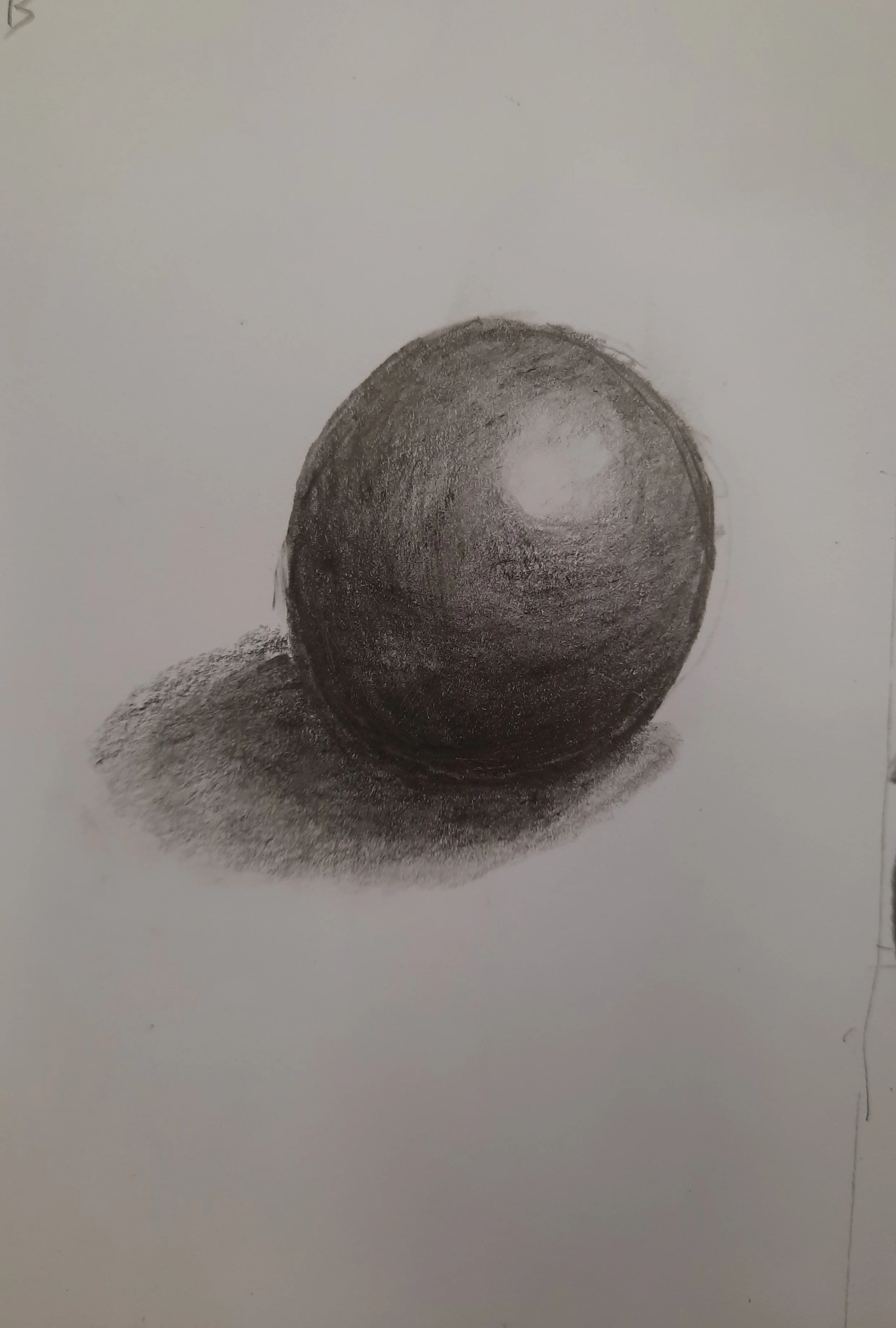 A realistic graphite sketch of a sphere with shading and a highlight, casting a shadow on the surface below.