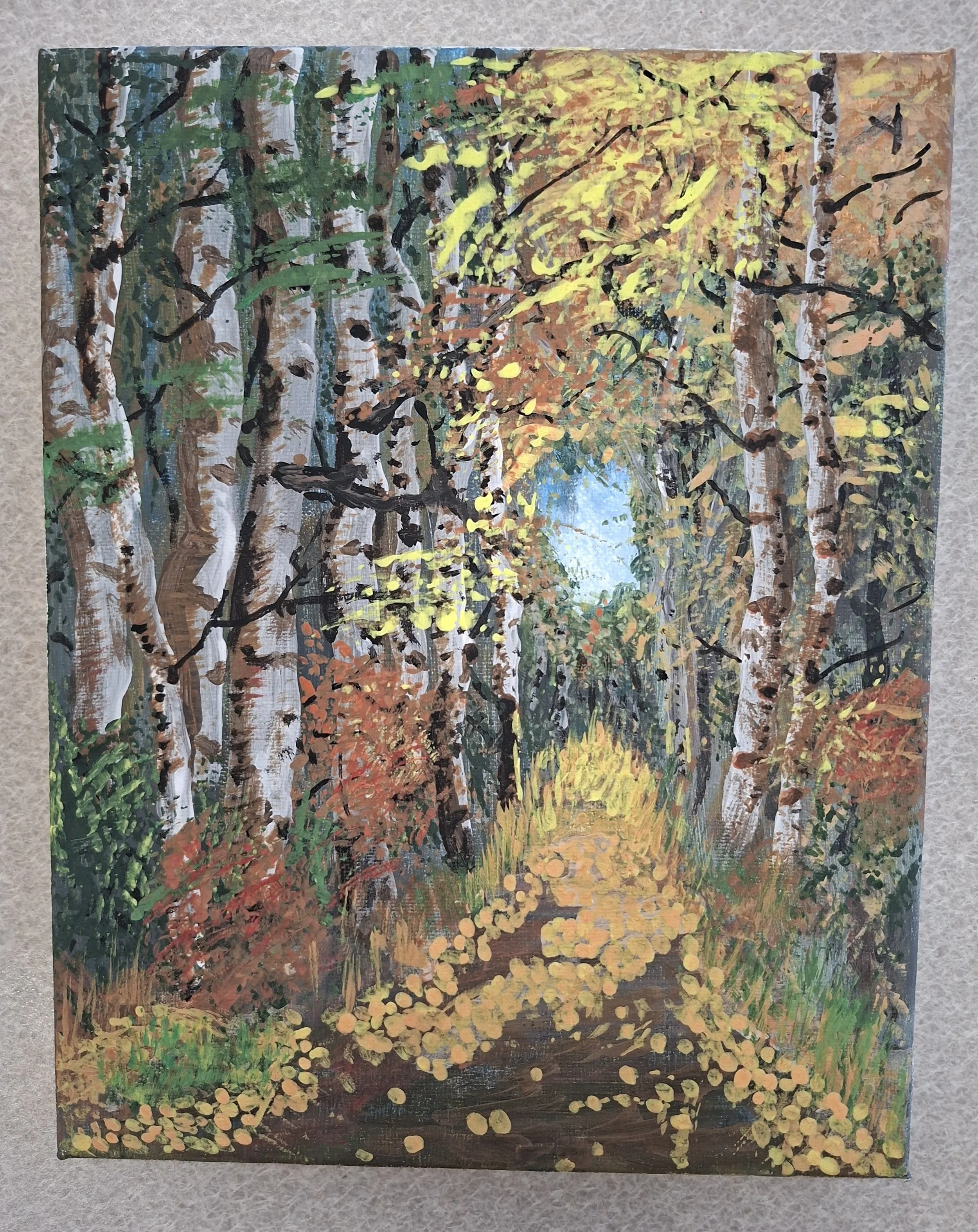 Painting of a forest trail with trees showing fall colors, seen through a canopy of yellow, orange, and green leaves, with a bright blue sky visible through the trees.