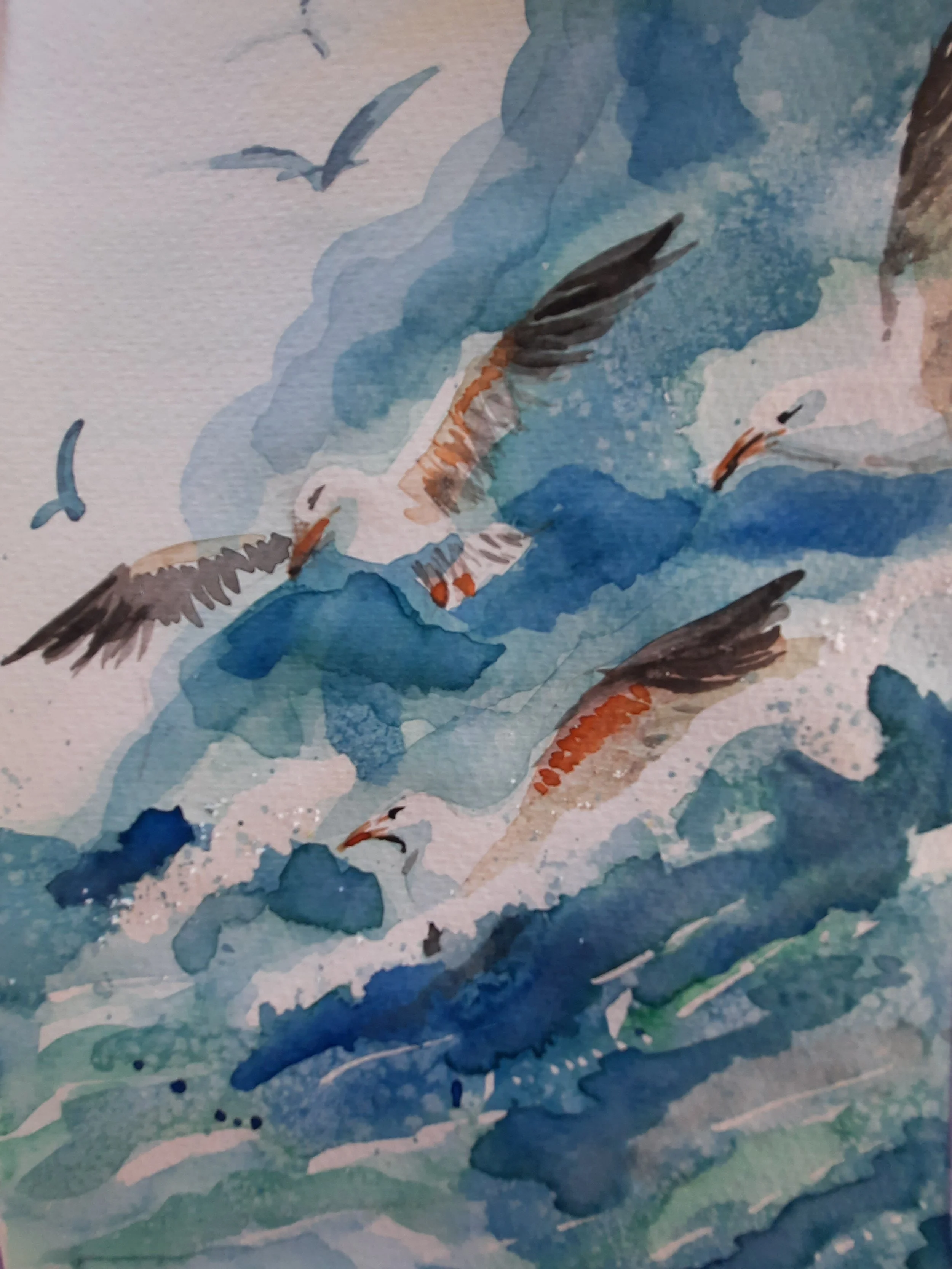 A watercolor painting depicting seagulls flying over a body of water with waves and a rocky shoreline.