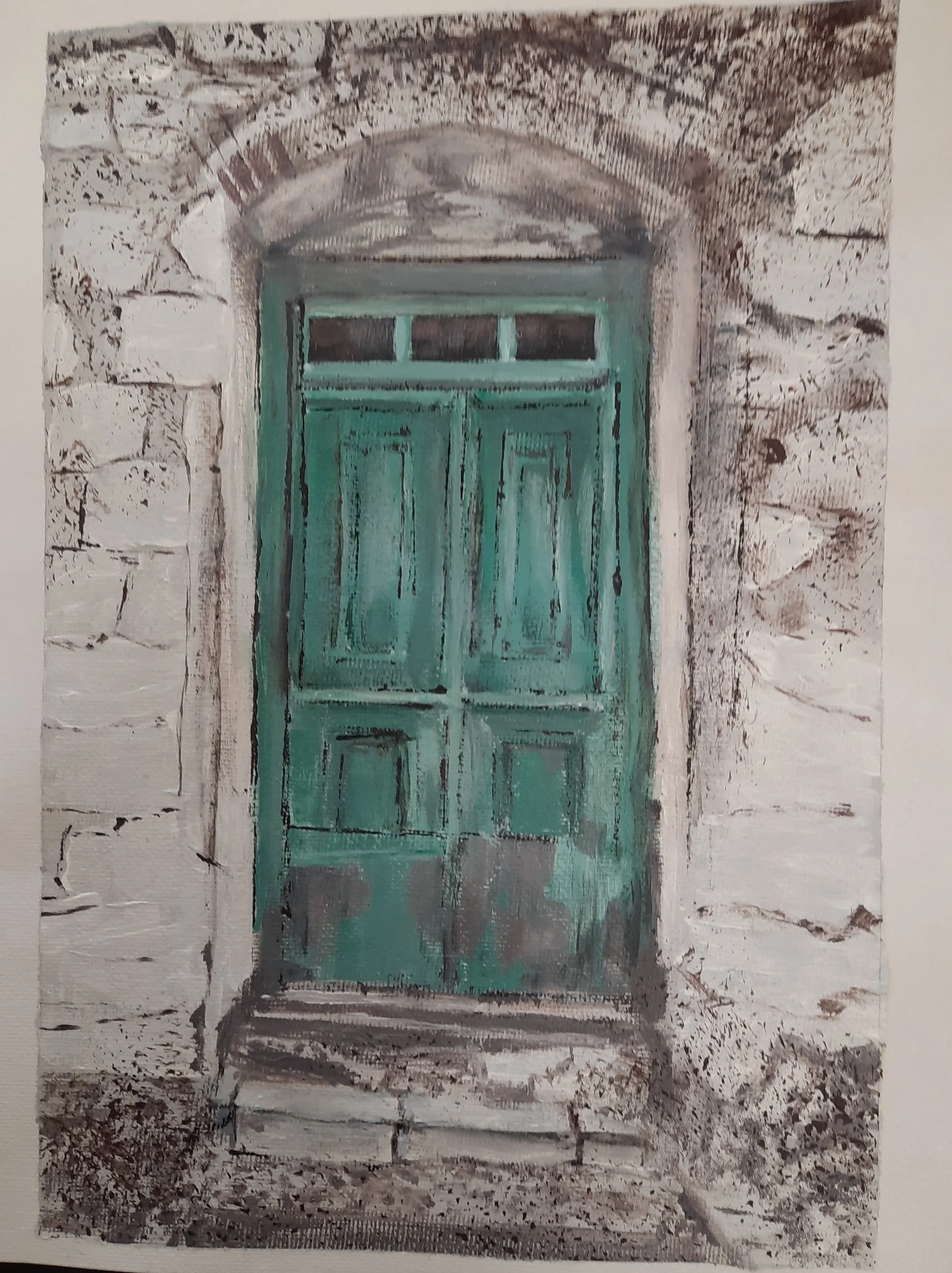 An old, weathered wooden door painted in turquoise, set in a stone wall with an arched lintel above.