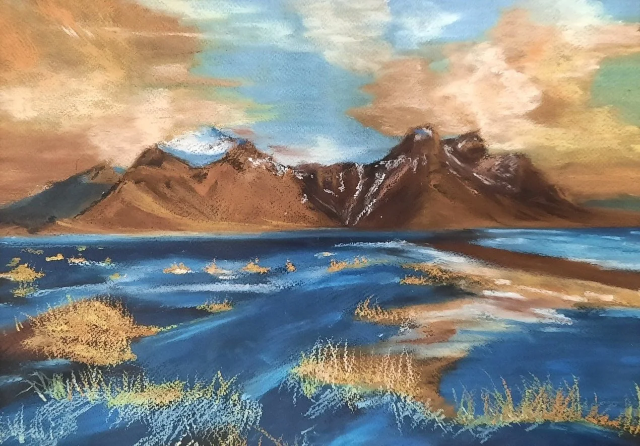 A painting of mountains with snow caps reflected in a body of water, with a cloudy sky in the background and grassy foreground.